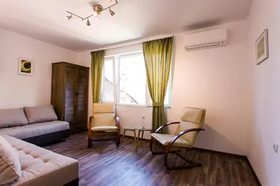 a living room with a couch and chairs at Top center big family apartment with garden view in Plovdiv