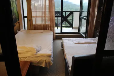 a small room with two beds and a window at Pamporovo Hotel Snezhanka A425 in Pamporovo