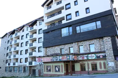 an apartment building with a black roof at Pamporovo Hotel Snezhanka A425 in Pamporovo
