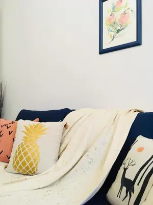 a blanket on top of a bed with pillows at Urban Garden in Sofia