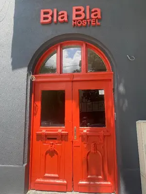 a red door on a building with a bia beta hospital at Bla Bla Hostel in Sofia