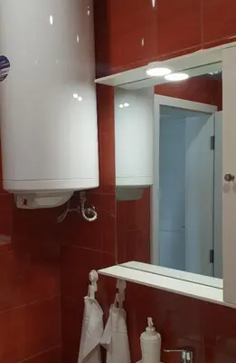 a bathroom with a mirror and a sink at Апартамент за нощувки in Gotse Delchev