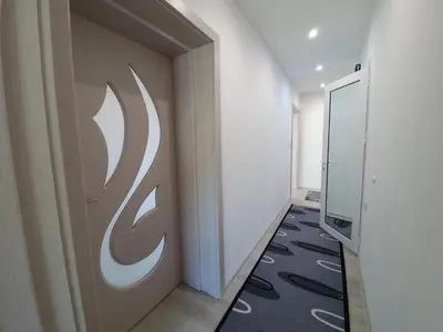 a hallway with a door with a logo on it at Д и В 2 - D & V 2 Apartment in Sandanski