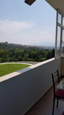 a balcony with a table and chairs and a view at Д и В 2 - D & V 2 Apartment in Sandanski