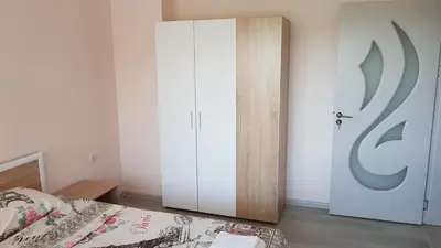 a bedroom with a bed and a white door at Д и В 2 - D & V 2 Apartment in Sandanski