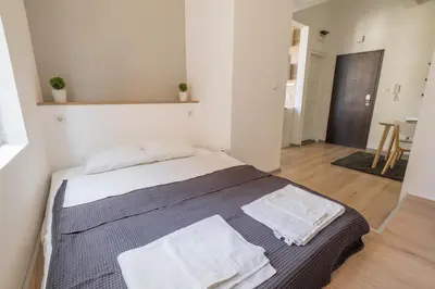 a bedroom with a bed with two towels on it at blueWaveplace - Contemporary Home in Center of Sofia in Sofia