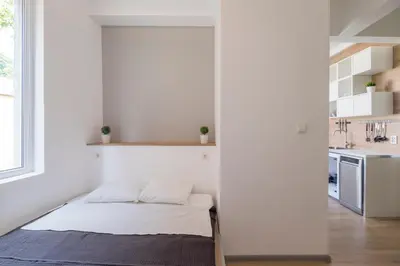 a bedroom with a bed in a white room at blueWaveplace - Contemporary Home in Center of Sofia in Sofia
