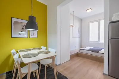a kitchen and dining room with a table and chairs at blueWaveplace - Contemporary Home in Center of Sofia in Sofia