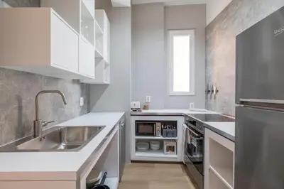 a kitchen with white cabinets and a sink at blueWaveplace - Stylish 2 BR Home in Center of Sofia in Sofia