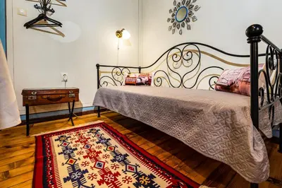 a bedroom with a bed and a rug at Blacksmith's House - Old Town in Plovdiv