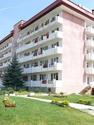 a large apartment building with a lawn in front of it at Почивна станция Витоша in Velingrad