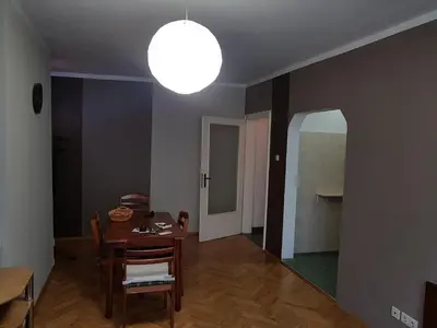 a dining room with a table and a light at Artistic studio in Sofia's top center in Sofia
