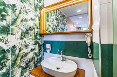 a bathroom with a sink and a mirror at Art Hotel Simona in Sofia