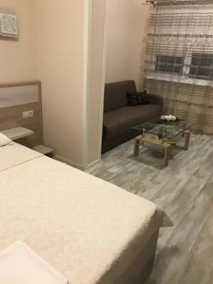 a living room with a couch and a table at ФЛАМА РЕЗИДЕНТС in Plovdiv