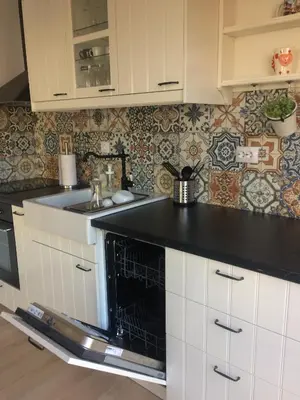 a kitchen with white cabinets and a black counter top at Willy Villy's Home- Chepelare in Chepelare