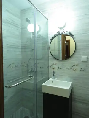 a bathroom with a shower and a sink and a mirror at Willy Villy's Home- Chepelare in Chepelare