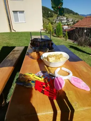 a wooden table with a bowl of food on it at Къща за гости МЕЛИСА in Borino