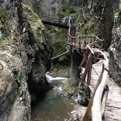 a bridge over a river with people walking on it at Къща за гости МЕЛИСА in Borino