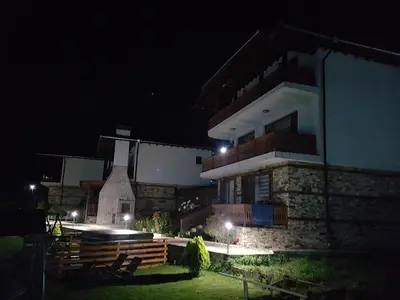a building at night with lights in front of it at Къщи за гости БАШЕВИ in Sarnitsa