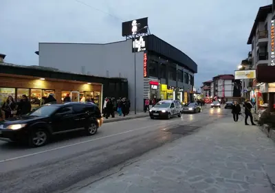 a busy city street with cars driving down the street at Family 2 bed Apartment in Bansko in Bansko