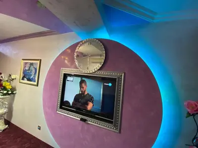 a flat screen tv on a wall with a mirror at Стаи за гости Топ Старс Смолян in Smolyan