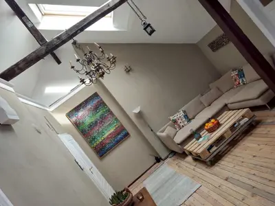 an overhead view of a living room with a couch and a painting at Good Stay Sofia Apartments in Sofia