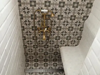 a shower in a bathroom with a tiled wall at Good Stay Sofia Apartments in Sofia