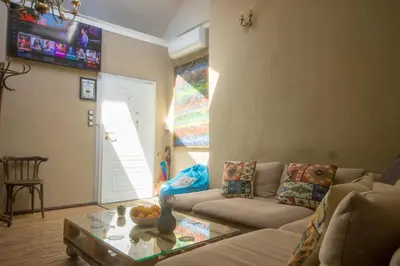 a living room with a couch and a table at Good Stay Sofia Apartments in Sofia