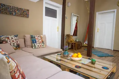 a living room with a couch and a table with a bowl of fruit at Good Stay Sofia Apartments in Sofia