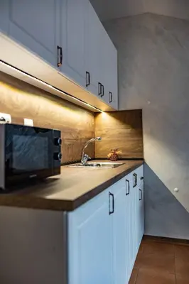 a kitchen with a sink and a microwave at Bansko home with a Mountain view in Bansko