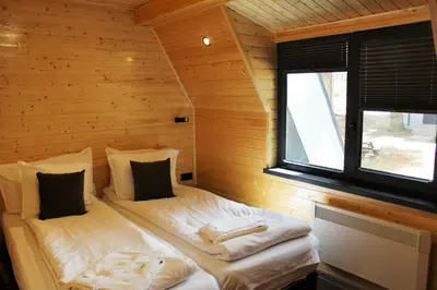 a room with two beds in a log cabin at Boro Green Holiday Village in Borovets