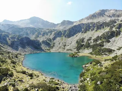 a mountain lake in the middle of a valley at Nice and quiet apartment next to Gondola lift. in Bansko