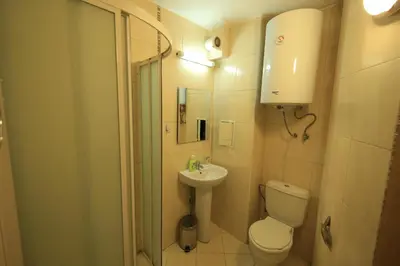 a bathroom with a toilet and a sink and a shower at Nice and quiet apartment next to Gondola lift. in Bansko