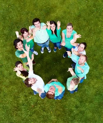 a group of people sitting in a circle in the grass at Luxury Chalet & Spa Tia Maria with Private SPA in Bansko