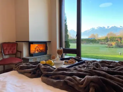 a bed with a tray of food and a fireplace at Luxury Chalet & Spa Tia Maria with Private SPA in Bansko