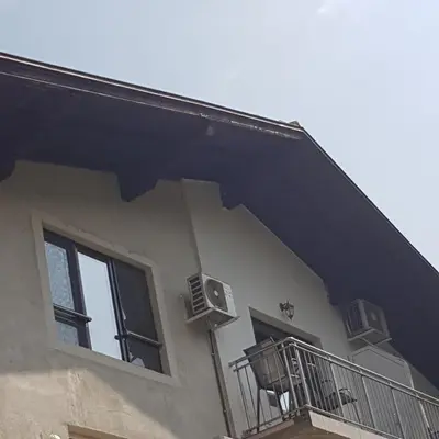 a building with two windows and a balcony at Guest House Ileana in Sapareva Banya