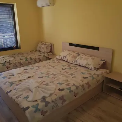 a small bedroom with a bed and a window at Guest House Ileana in Sapareva Banya