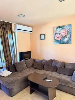 a living room with a brown couch and a table at VIP Complex in Sarnitsa