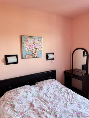 a bedroom with a bed and a painting on the wall at VIP Complex in Sarnitsa