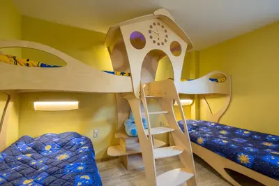 a bunk bed room with two bunk beds and a ladder at Villa ADELHEIDE - Spa, BBQ & Jacuzzi in Beli Iskar