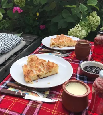 two plates of food on a picnic table at Dream house in Leshten