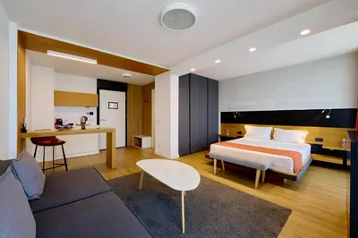 a hotel room with a bed and a desk at Adella Boutique Hotel - Free Secured Parking in Sofia