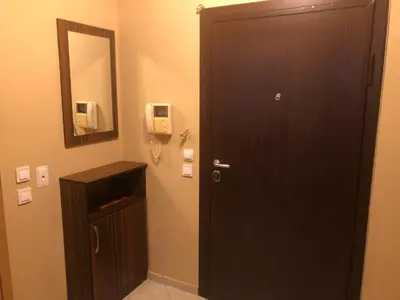 a bathroom with a brown door and a mirror at Rakovski Apartment GN / FREE GARAGE in Sofia