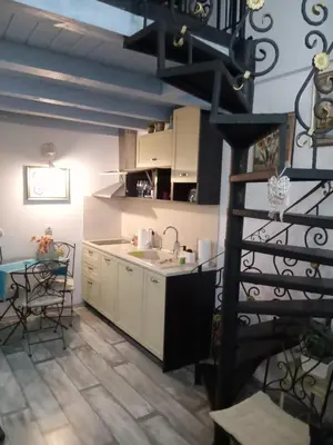 a kitchen with a sink and a table in a room at Cosy House in Sofia