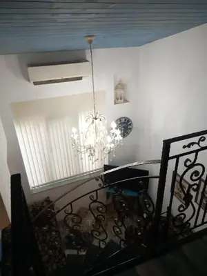 a chandelier hanging from a ceiling in a room at Cosy House in Sofia