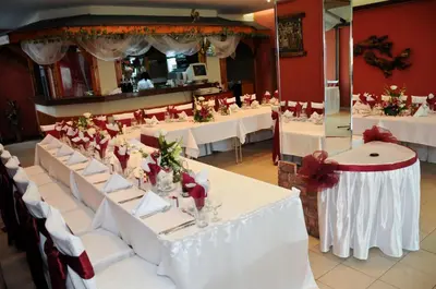 a banquet hall with white tables and red walls at Park Hotel Ribaritsa in Ribarica