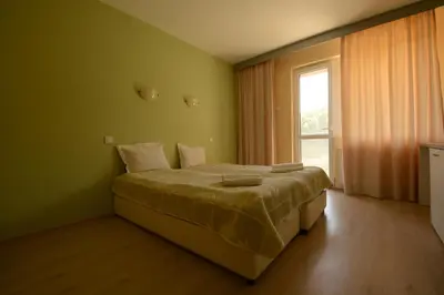 a bedroom with a bed in a room with a window at Park Hotel Ribaritsa in Ribarica
