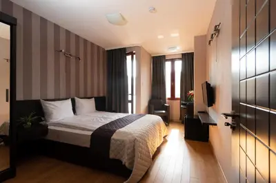 a hotel room with a bed and a television at CityHome Aparthotel in Sofia