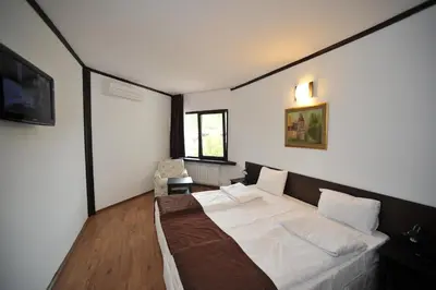 a bedroom with a large white bed in it at Hotel Melnik Хотел Мелник in Melnik