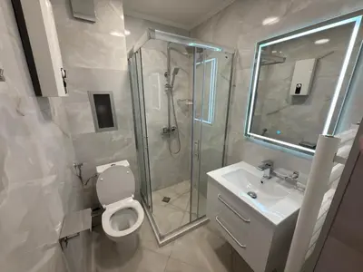 a bathroom with a shower and a toilet and a sink at Apartment 24 in Pamporovo